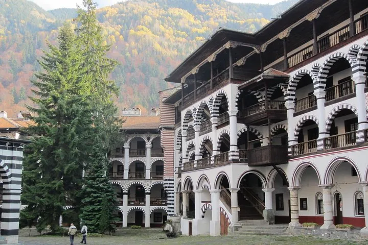 View of the courtyard and residential quarters at Rila Monastery surrounded by mountains