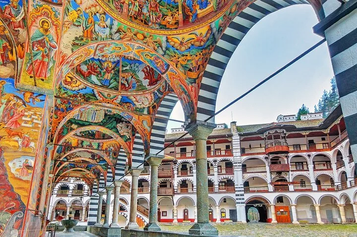 Intricate, colorful frescoes on the ceilings and arches of Rila Monastery's exterior